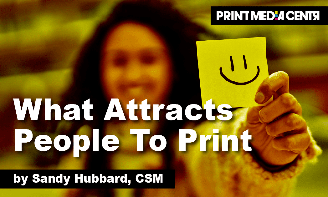 a young women holding a happy face on yellow paper